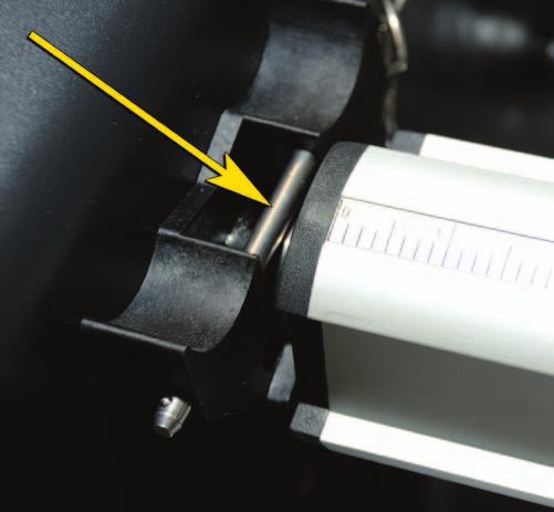 4. Slide the roll of film onto the film shaft, ensuring the adhesive does not make contact with the roller. 5. Insert the film shaft back into the film shaft Support Saddle. 6.