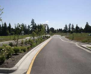 Retrofit Conditions: Figure C-5: This new green street is designed as a reverse crowned street,allowing runoff to flow into a center median vegetated swale.