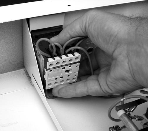 REMOVING THE RELAY WARNING 4. Push down on the top of the relay case and rotate the lower rear up to unclip the relay from the front panel.