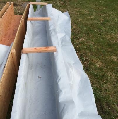 The geotextile rolls were then recovered with plastic bags before installation and temporarily put on the test section.