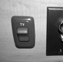 TV - 12-VOLT LCD (Pull-Down/Pivot Mechanism) - If Equipped To Bring Down/Pivot TV: 1. Release the TV by pushing up on knob at the bottom of the TV mounting assembly.