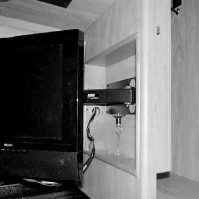 Release the TV by pulling straight down on the pull chain (located inside the rear storage cabinet).