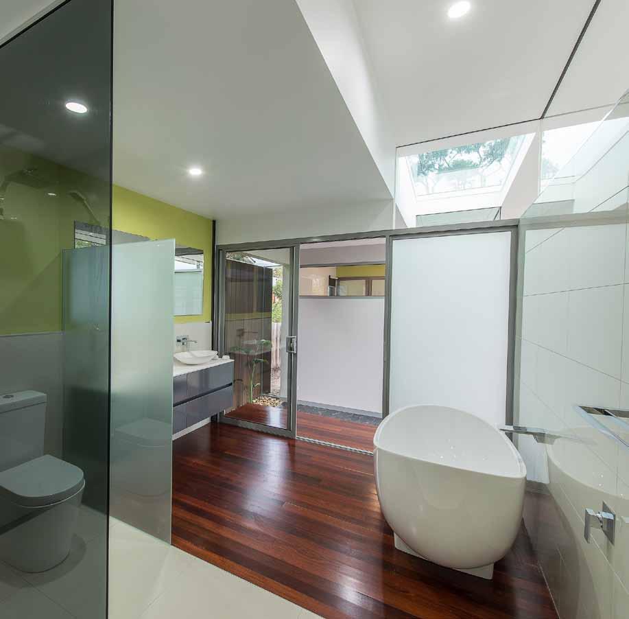 the main bathroom makes clever use of its position next to the internal courtyard and maximises this garden space with access via a sliding Door.