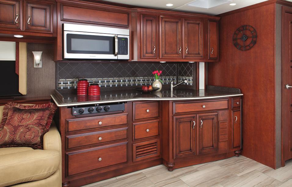 accented by a handsome glass and marble backsplash, and an expandable four-person dinette.