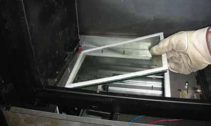 Glass Pane Frame. Figure 8.9 Removing Screws from Base Pan. Figure 8.13. Removing Glass Pane Frame. Figure 8.10 Lifting Base Pan Up and Out.