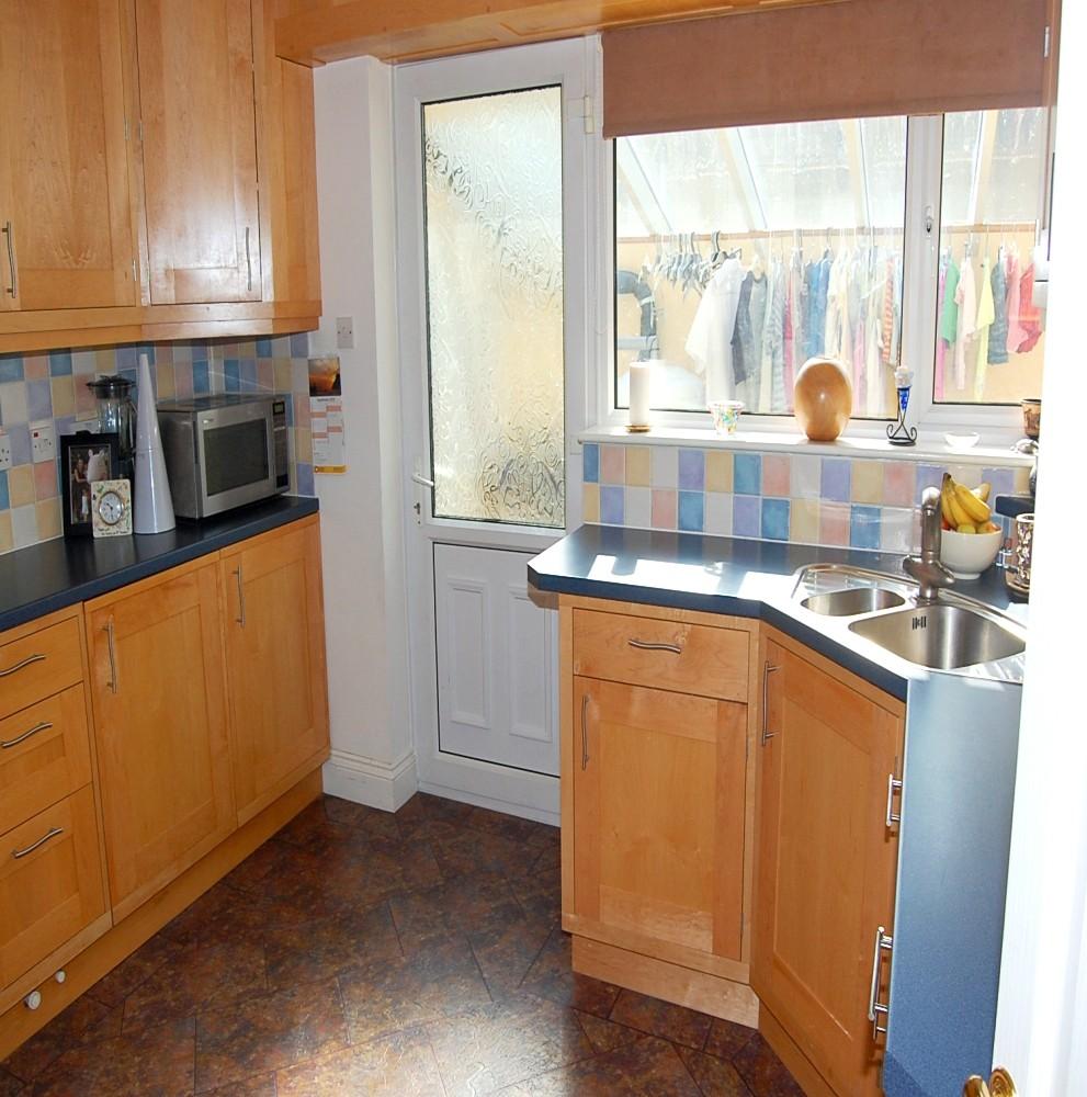 Fitted with base units and laminate work surfaces with a single stainless steel sink. Space for fridge. Plumbed for automatic washing machine and tumble dryer.