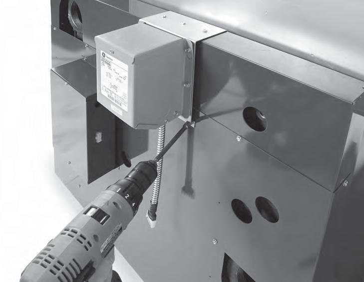 Attach transformer and bracket assembly to jacket end panel by using #10 x ½ screws; (3) along