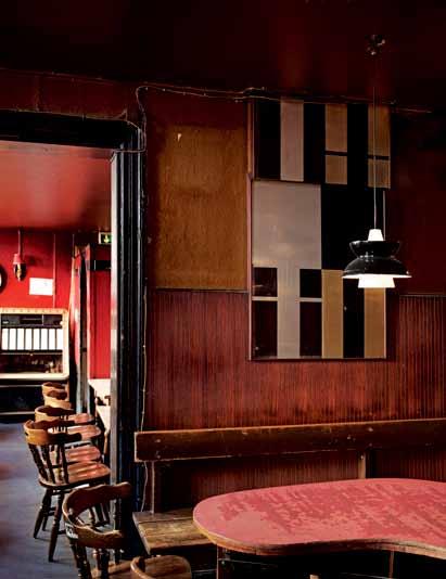 It still has the original furniture, worn tables and once deep-red curtains, which create the special pub atmosphere.