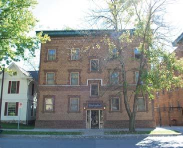 Historically, this type of multistory building was often built as a boarding house or apartment building with multiple rooms or units which could be rented by