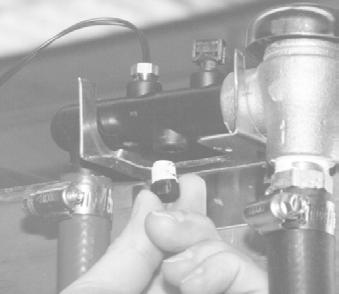 The supply tube connects on the left side of the pump; the discharge tubing connects on the right side of the pump. 5. Remove the 1/8" plug located in the final rinse manifold. 6.