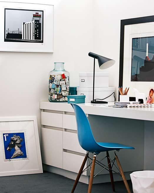 A print of Battersea Power Station by Paul Catherall is perched on the desk, and a quirky screenprint Barely Legal Queen by James Cauty sits on the floor.