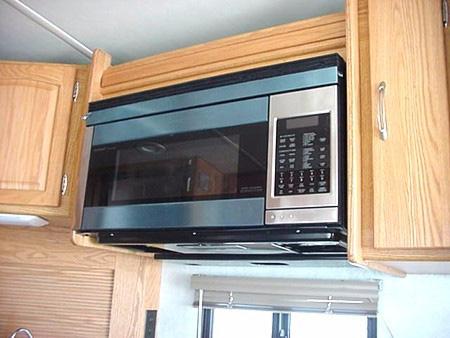 SECTION 4 APPLIANCES & SYSTEMS RANGE HOOD The range hood vent is built into the underside of the microwave oven. The range hood fan carries cooking odors and gas fumes to the outside of the coach.
