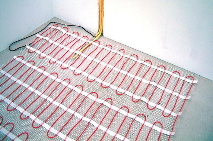 Apply a first layer of Flexible tile adhesive 0,4 cm to 0,6 cm thick and approx. 55 cm wide. Roll the mat out over the tile cement with the cable facing downwards.