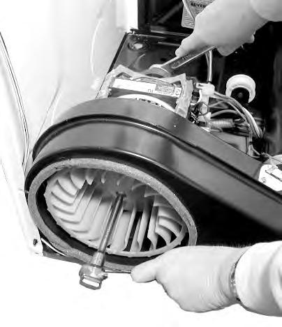 d) Turn the blower wheel clockwise (shown by the REMOVE arrow that is embossed on the front of the wheel ) and remove the wheel from the motor shaft.