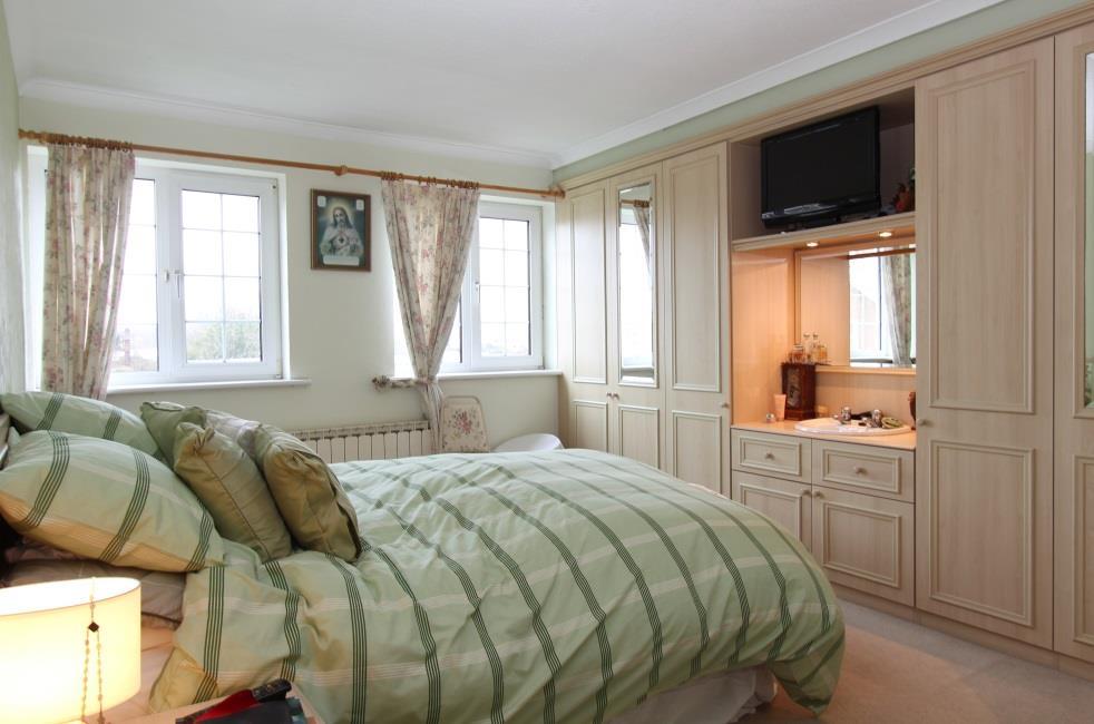 Bedroom 1 15 9 x 11 4 Fitted with a range of bedroom furniture comprising a run of six door wardrobes to