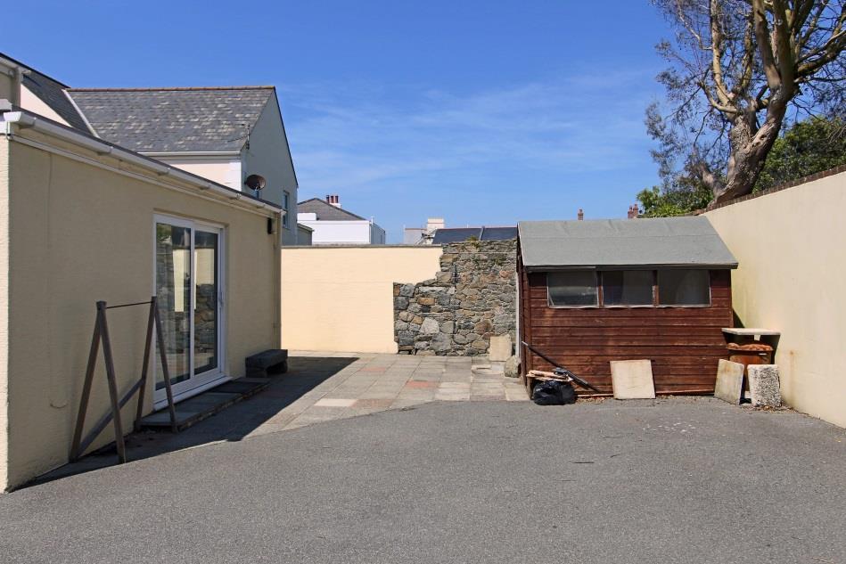 The property owns 8 feet from the gable wall where there is parking for 3 cars in tandem.