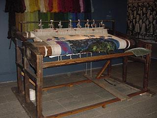 Tapestry Weaving: Tapestries are made by weaving threads together on a loom. A tapestry loom must hold parallel "warp" threads in tension, so "weft" threads can be woven back and forth between them.