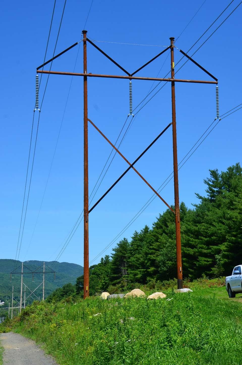 Vermont Electric Power Company - Connecticut River Valley Project Figure 5: View of recent 345 kv replacement structure in foreground, with an existing wooden 345 kv structure similar in the