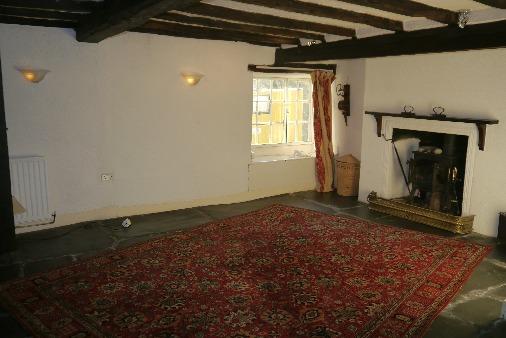 Spice cupboard dated 1680. First floor landing with original exposed floorboards and oak panelled wall.