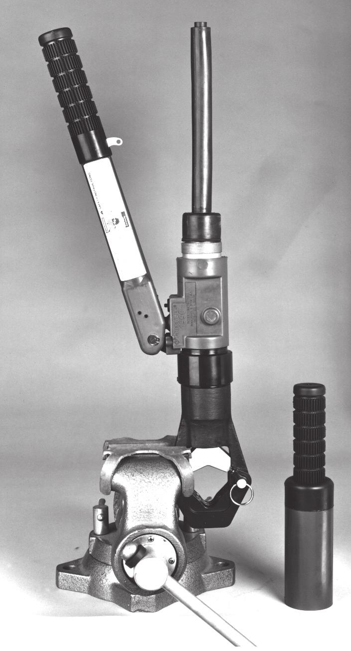 1. Clamp the tool into a vise with jaw protectors so the handles are upward, as shown. Reservoir Plug (25) Vise with Jaw Protectors Rubber Plug (26) 6. Retract the ram fully. 7.