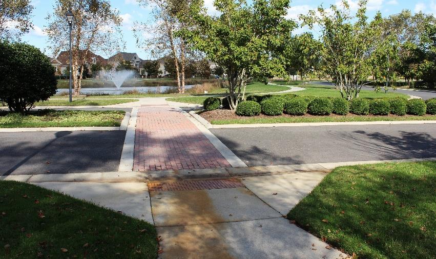 Entrances and driveways should permit safe and convenient pedestrian crossing where they intersect sidewalk and other pedestrian
