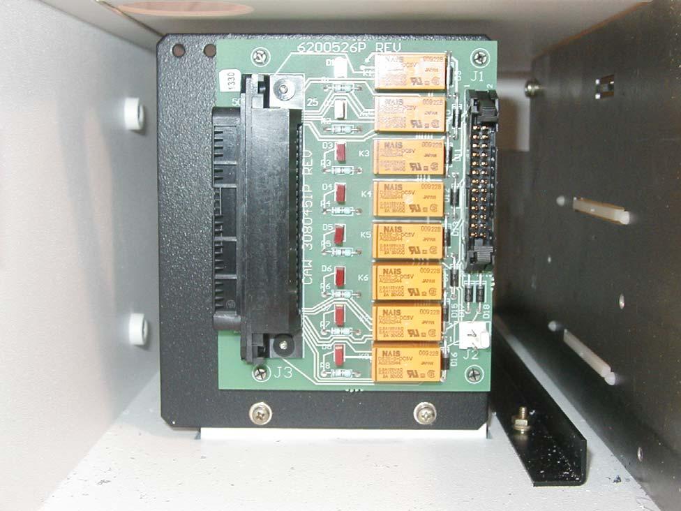 1.19 ALARM EXTENSION CONNECTIONS Located to the left of the MMC, as shown in Figure 19, is where the PWB containing installer connections for the system alarms is located.