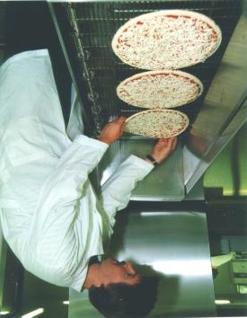 Methods extra conveyor width fell equally to each side of the pizza row, rather than on just one side or between the pizzas.