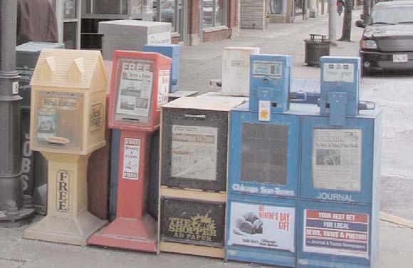Decorative newspaper stands should be located throughout Downtown and near the train station to consolidate numerous newspaper boxes.