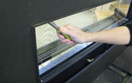 GLASS REMOVAL: 1. With the screen removed, loosen the ¼-20 bolts along the top edge of the glass frame using a 7/16 socket. 4.