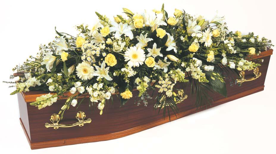 CS2 Classical white and cream full length coffin spray comprising of Roses, Lilies, Gerbera and Philox complemented by seasonal foliage.