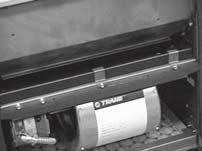Figure 33. To remove the main drain pan on vertical fan-coil units, disconnect the clips holding the pan to the fanboard.