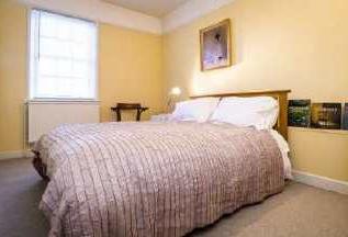 This is an elegant, sizeable bedroom, having the benefit of individual period fireplace together with cast iron inlay with open grate, twin fitted cupboards, twin Georgian windows with period