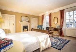 66m) A sizeable double bedroom, with ornate fire surround with cast iron inlay, walk-in Georgian window with secondary glazing, window seat and views over side garden, two central heating radiators,