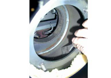 fan wheel from the inside out using a soft brush or paint brush Remove dirt and deposits from the induced draught housing using a scraper Remove any ash which has gathered