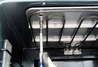 (See Control Compartment Access.) Remove the three ¼-in. hex-head screws that attach the vent trim to the oven. Remove the vent trim. Disconnect the left side light wire harness. Disconnect 7.