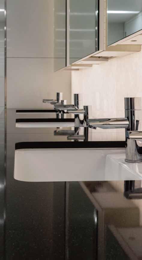 We designed the ideal modern washroom: mounted taps to minimise counter splash, bespoke combination units with special makeup bins to prevent toilet blockages and even matching sanitiser and toilet