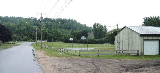 Basketball Court: The basketball court is in poor condition, but useable. The hoops are rusty, outdated and have no net.