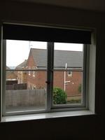 with white handle, brown roller blind to window, clean