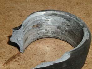 A connecting rod big end is seized and broken due to a lack of lubrication.