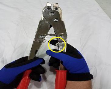Pull down the ratchet release lever using your left thumb.