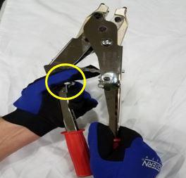 Pull down the ratchet release lever with your right index finger.