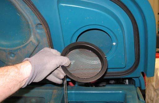 11. Remove the vacuum screen from the recovery tank cover and rinse the screen.