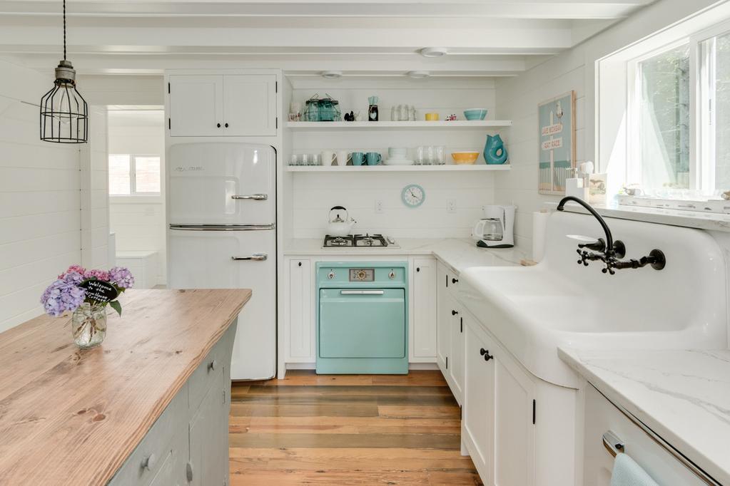 This shabby chic beach kitchen is blanketed in a crisp white, complete with a