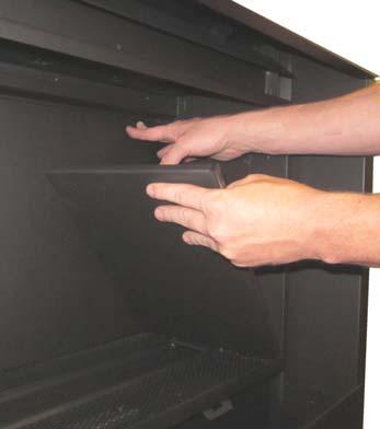 They are located at the outward edges of the firebox near the glass opening.