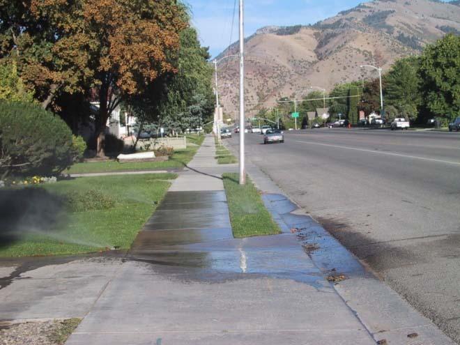 waterways by washing pollutants into the sewer system. problem causing reduced sprinkler coverage and uniformity. Figure 7. Misaligned sprinklers spraying across sidewalk and into road.