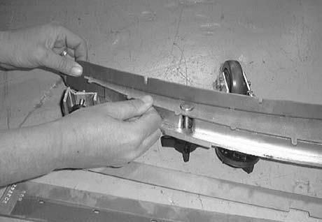 Tighten the two outside knobs on top of the squeegee assembly. 9. Insert the rear squeegee blade and retainer.