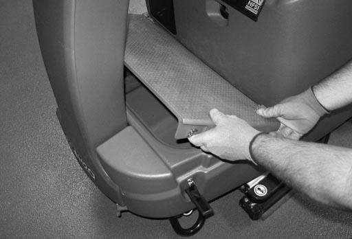 Unhook the seat latch and lower the operator seat. 11.