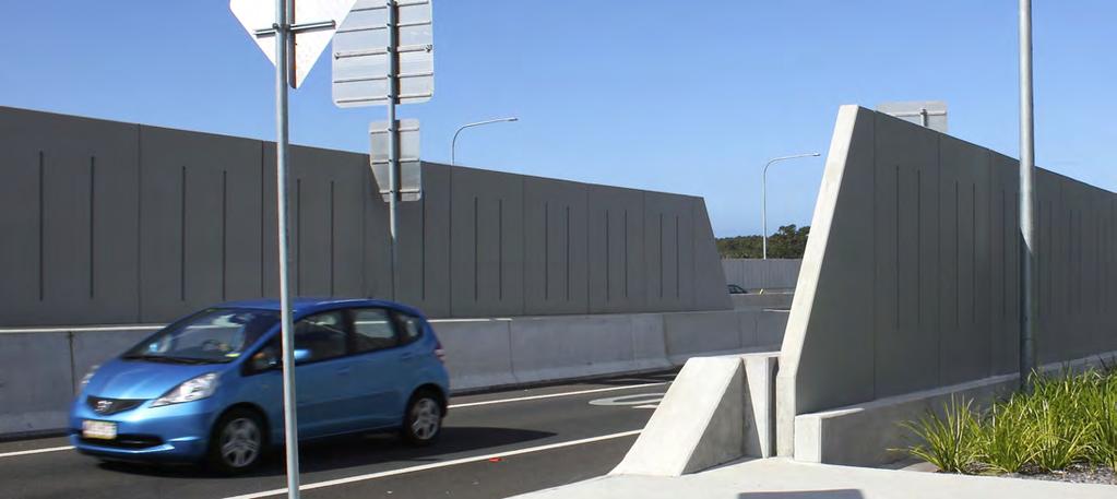 The walls are comprised of vertical precast concrete wall panels, to be supported on cast-in-place piles behind the road safety barriers.