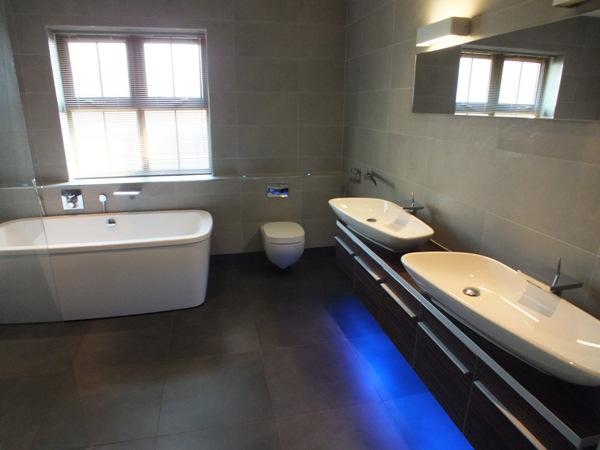 En Suite Bathroom (approx 9 7 x 8 5) Fitted with a white four piece suite comprising enclosed wet room shower cubicle, bath, vanity wash hand basin and toilet. Fully tiled walls and flooring.