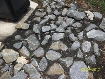 Remove riprap, stone, or mulch contaminated with sediment. Clean all sediment from the inflow area. If riprap is used, clean off and replace with original stone, supplemented as needed.